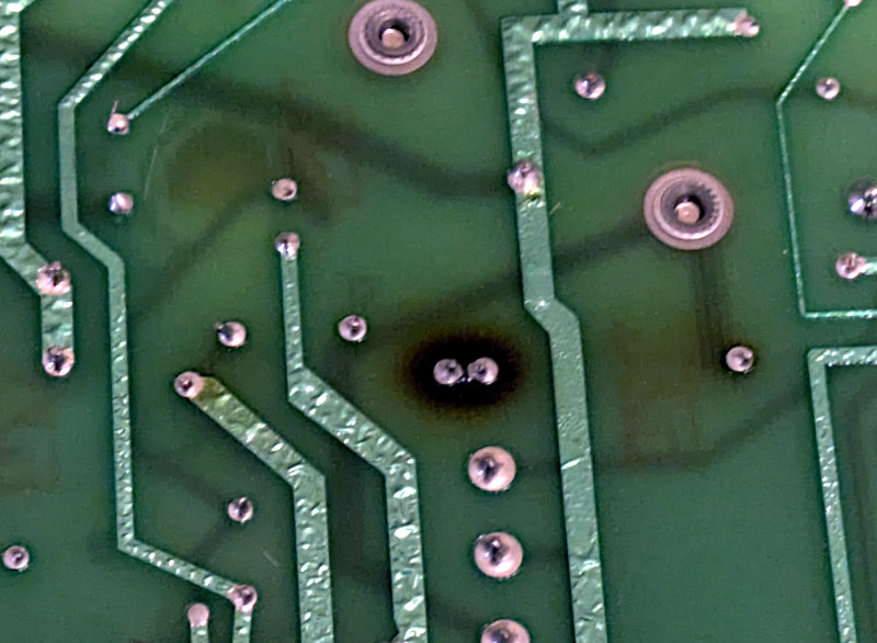 [Really bad picture of burnt mainboard]